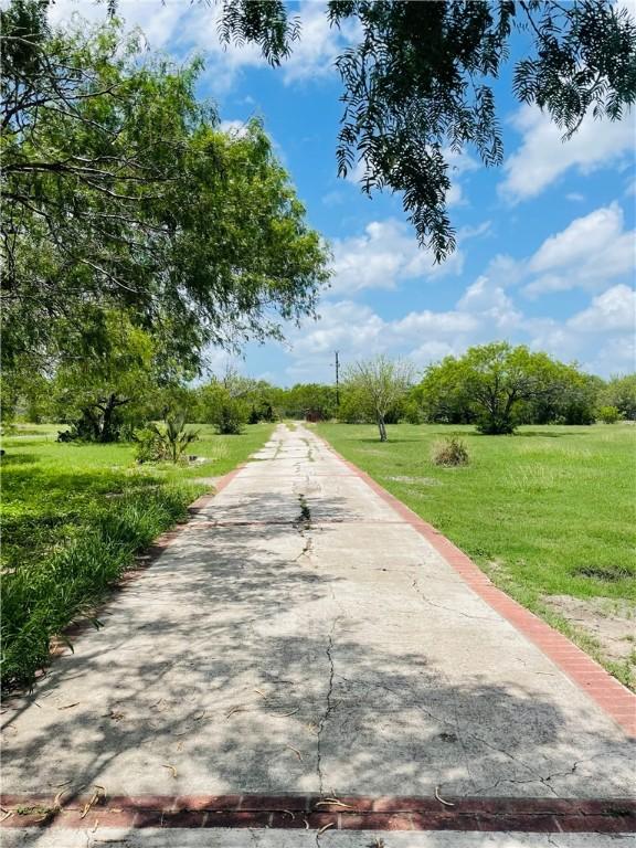 5742 Hidden Valley Loop, Sandia, TX 78383 - view of property's community with a lawn