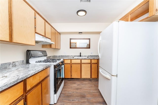 3606 Marion St, Corpus Christi, TX 78415 - kitchen with freestanding refrigerator, gas stove, under cabinet range hood, dark wood finished floors, and light stone counters