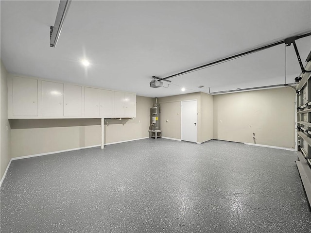 garage featuring water heater, baseboards, and a garage door opener