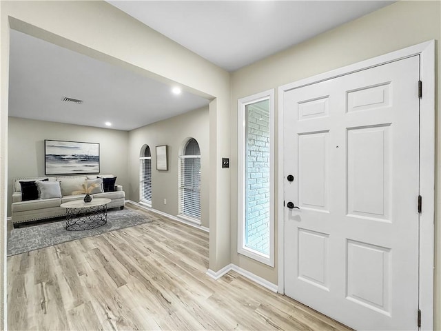 entrance foyer featuring baseboards, visible vents, and light wood-style floors