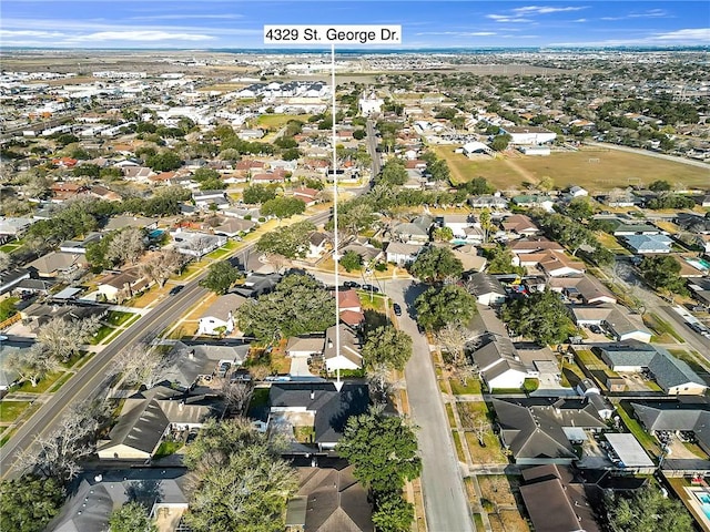 birds eye view of property with a residential view