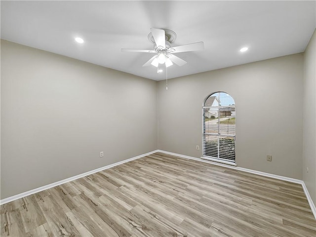 empty room featuring a ceiling fan, recessed lighting, light wood-style flooring, and baseboards