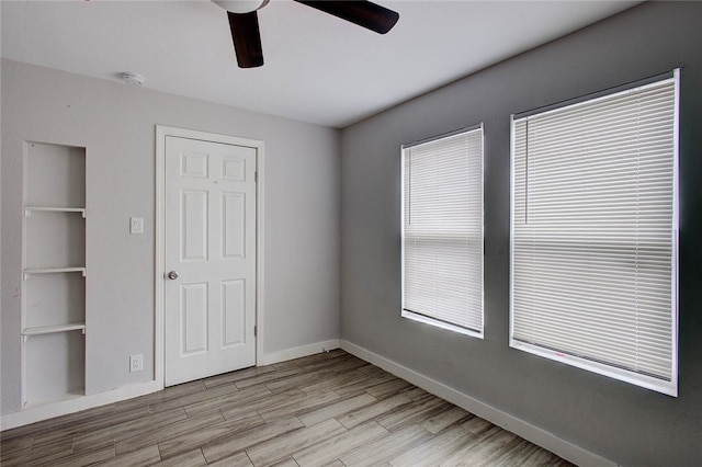 unfurnished bedroom with a closet, light hardwood / wood-style floors, and ceiling fan