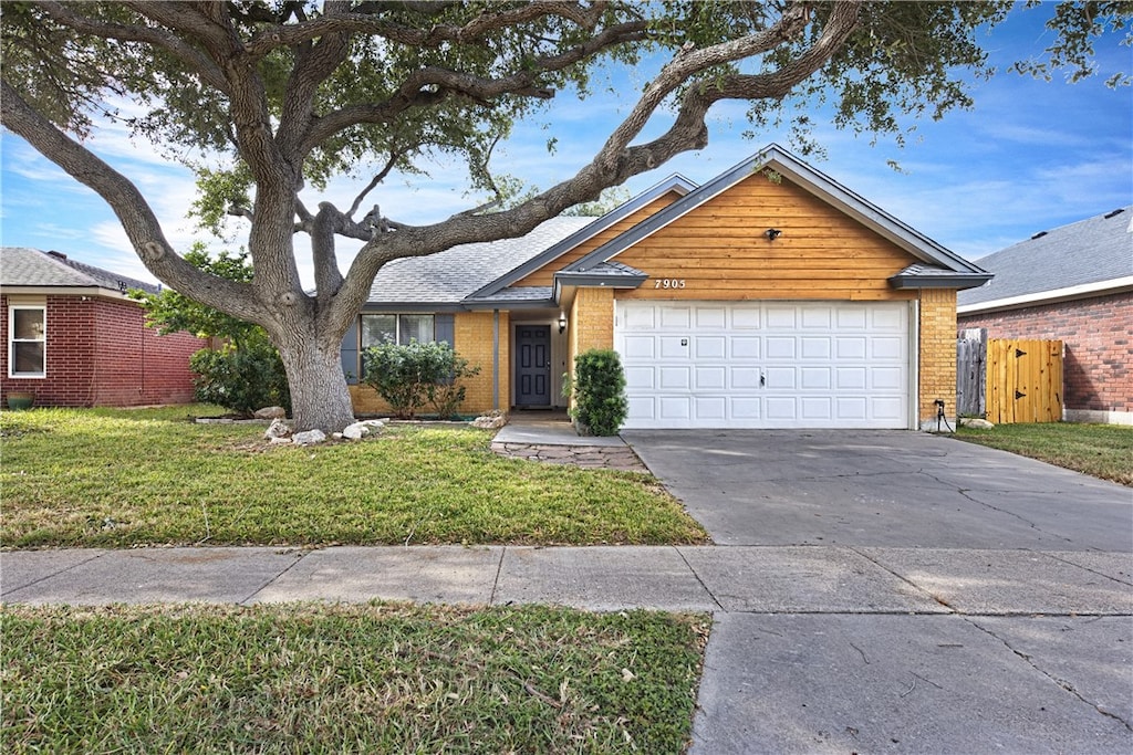 ranch-style house with a garage and a front yard