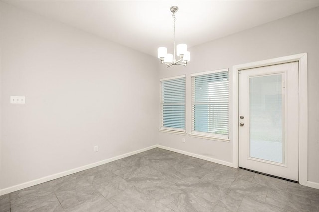 spare room featuring a notable chandelier