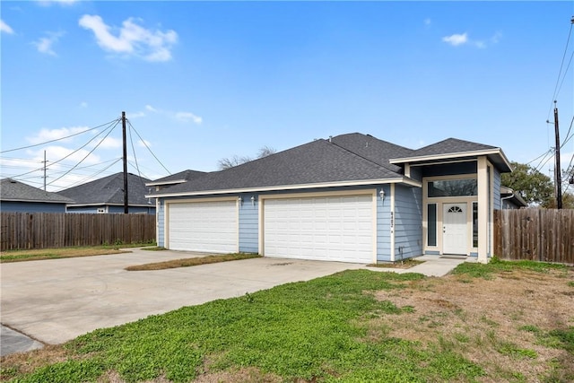 ranch-style house featuring a garage and a front lawn