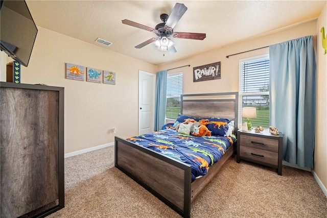 bedroom featuring light carpet and ceiling fan