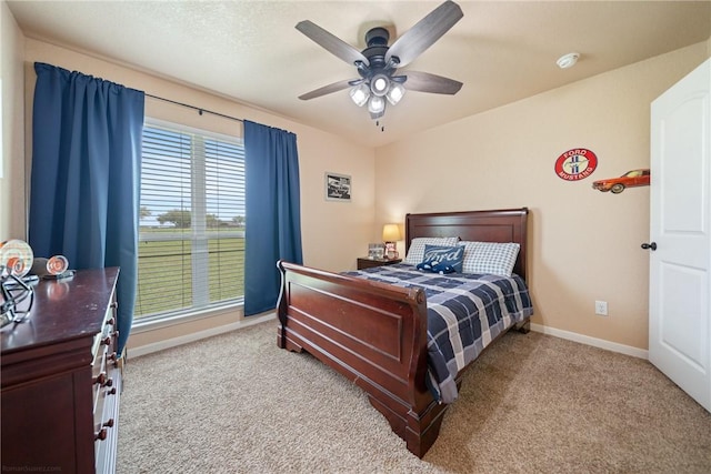 bedroom featuring light colored carpet and ceiling fan