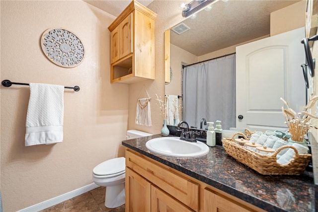 bathroom with vanity, tile patterned flooring, a textured ceiling, and toilet