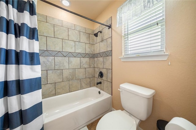 bathroom with toilet and shower / bath combo with shower curtain