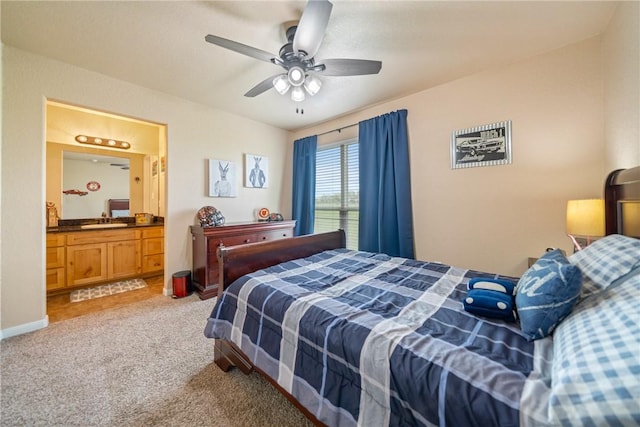 carpeted bedroom with connected bathroom, sink, and ceiling fan