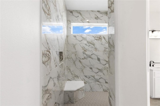 bathroom with a marble finish shower