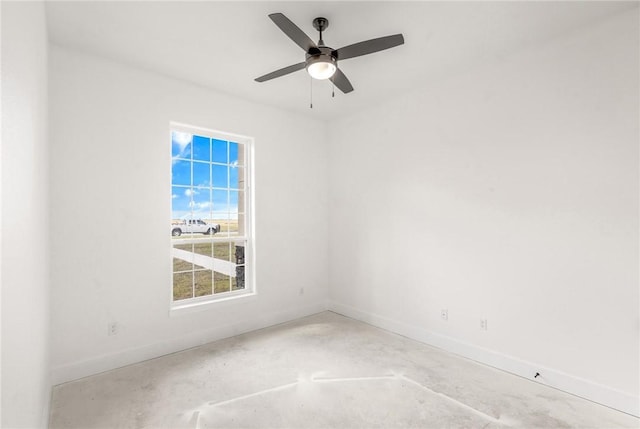 unfurnished room featuring ceiling fan, concrete floors, and baseboards