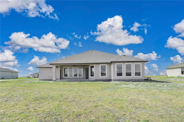 rear view of property with a lawn