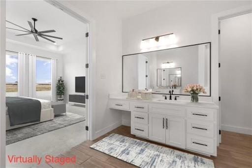 bathroom with vanity, wood finished floors, baseboards, and a ceiling fan