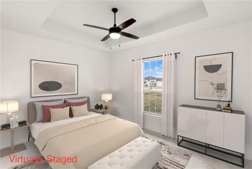 bedroom featuring a raised ceiling and ceiling fan