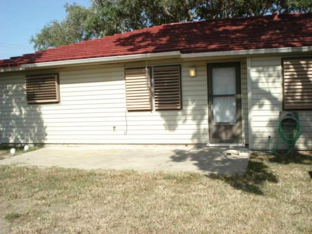 back of house featuring a yard and a patio