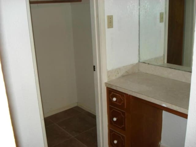 bathroom featuring tile patterned flooring and vanity