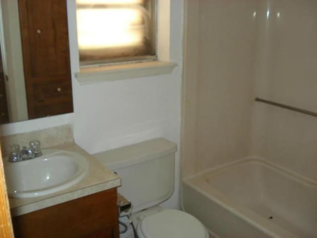 full bathroom with vanity, bathtub / shower combination, and toilet