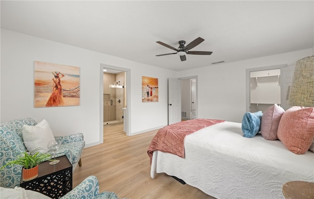6905 Braesvalley Dr, Corpus Christi, TX 78413 - bedroom with light wood-style floors, a spacious closet, connected bathroom, and ceiling fan