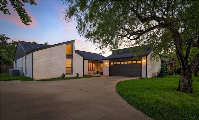 6905 Braesvalley Dr, Corpus Christi, TX 78413 - view of front facade with concrete driveway, a garage, and a lawn