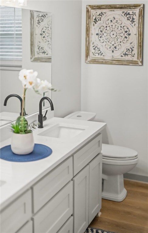 6905 Braesvalley Dr, Corpus Christi, TX 78413 - bathroom featuring double vanity and wood finished floors