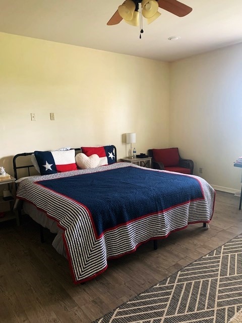 bedroom with hardwood / wood-style flooring and ceiling fan