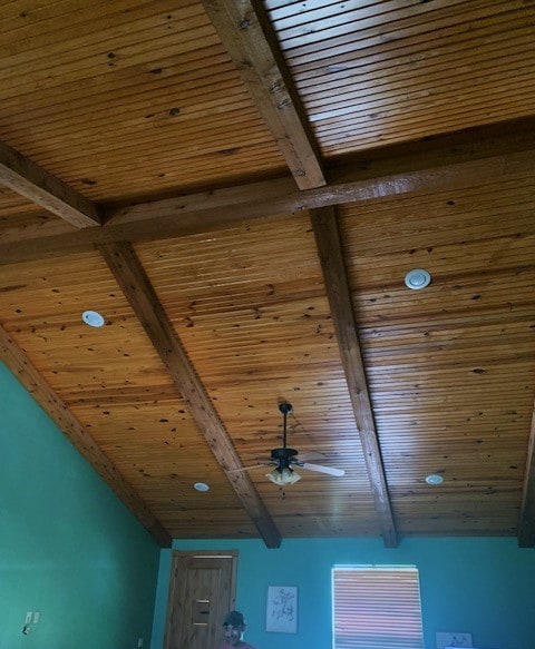 room details with beamed ceiling, wood ceiling, and ceiling fan