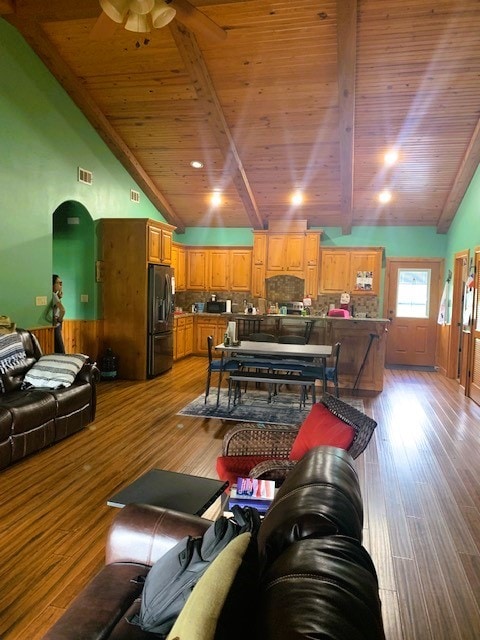 living room with ceiling fan, wood ceiling, vaulted ceiling with beams, and light hardwood / wood-style flooring