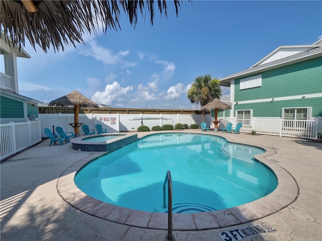 view of pool with an in ground hot tub and a patio area