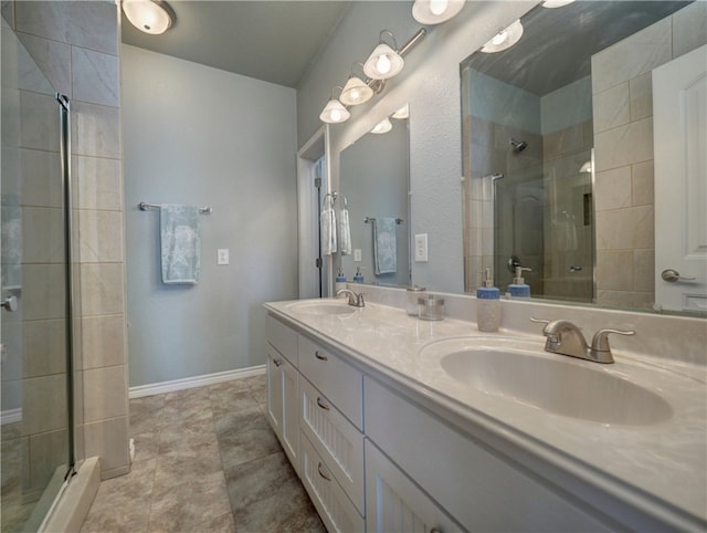 bathroom featuring tile patterned flooring, vanity, and a shower with door