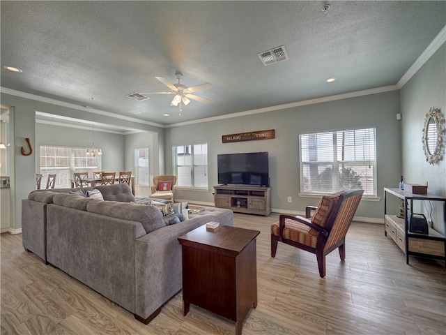 living room featuring ceiling fan, a healthy amount of sunlight, and light hardwood / wood-style flooring