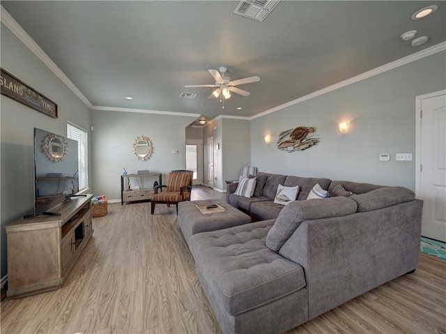 living room with light wood-type flooring, ceiling fan, and ornamental molding