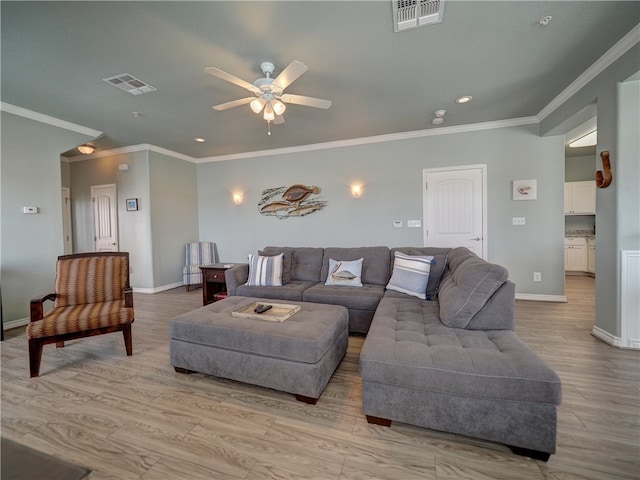 living room featuring light wood-type flooring, ceiling fan, and ornamental molding