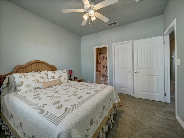 carpeted bedroom featuring ensuite bath, ceiling fan, and a closet