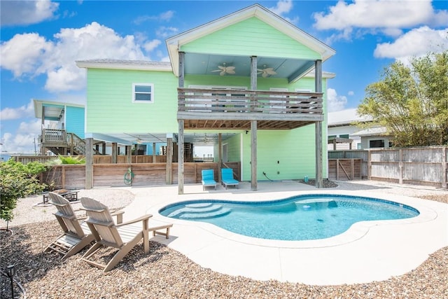 view of pool featuring a patio area, a ceiling fan, a fenced backyard, a wooden deck, and a fenced in pool