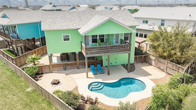 rear view of property with a patio area, a fenced backyard, a residential view, and roof with shingles