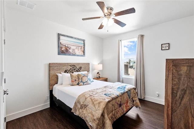 bedroom with dark wood-style flooring, baseboards, a ceiling fan, and visible vents