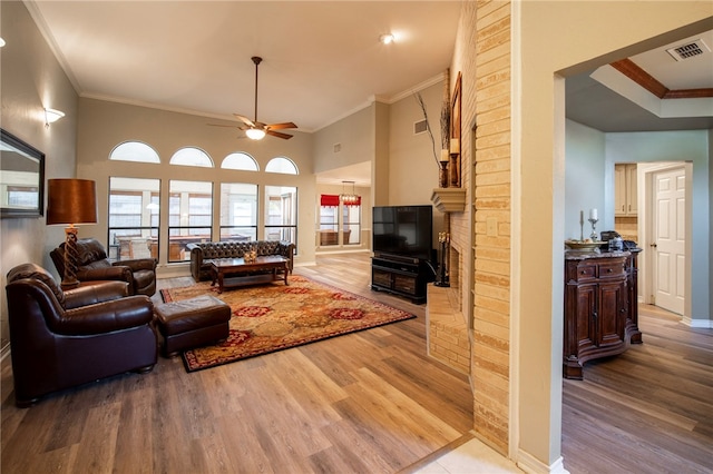 living room featuring ornamental molding, ceiling fan, and light hardwood / wood-style floors