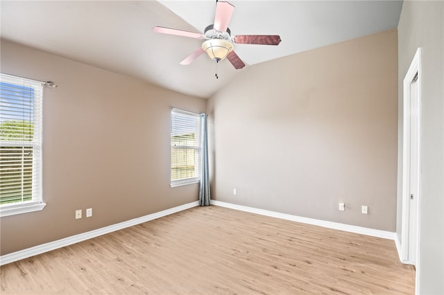 unfurnished room with ceiling fan, light wood-type flooring, and lofted ceiling