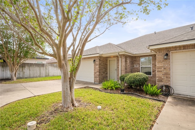 ranch-style house with a garage and a front lawn