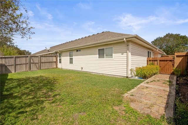 rear view of house featuring a yard