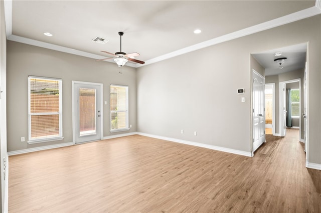 empty room featuring ceiling fan, light wood-type flooring, and crown molding