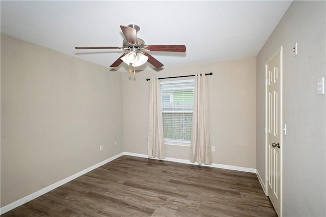 spare room with dark hardwood / wood-style floors and ceiling fan