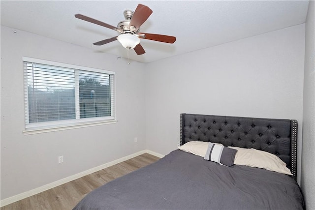 bedroom with wood-type flooring and ceiling fan