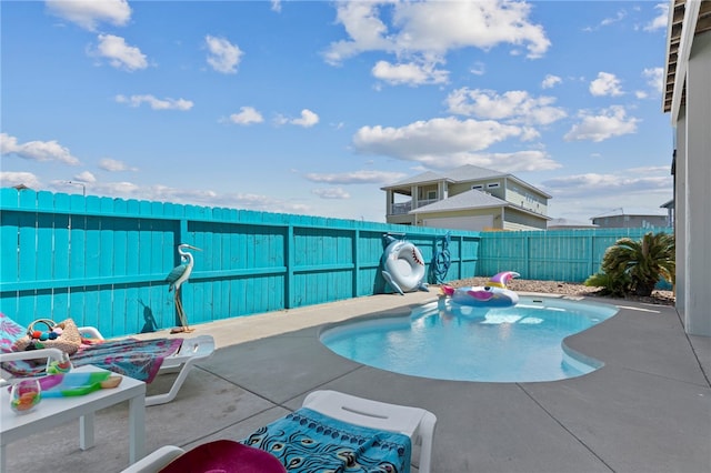 view of swimming pool with a patio area