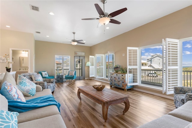 living room with light wood-type flooring and ceiling fan