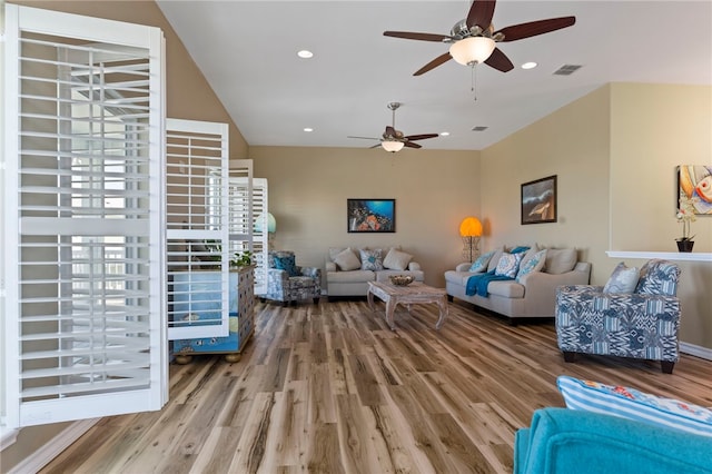 living room with wood-type flooring and ceiling fan