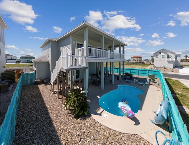 back of property featuring a patio area and a balcony