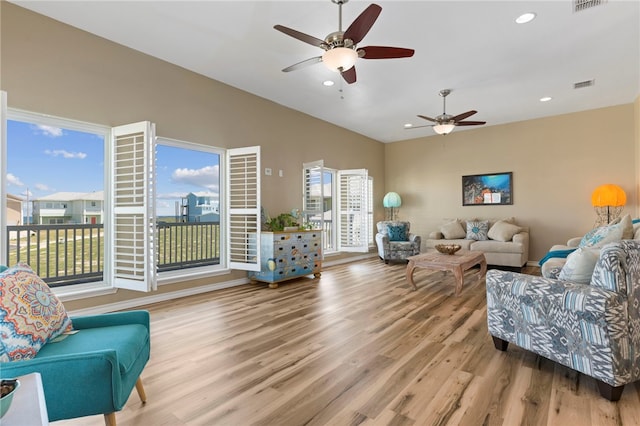 living room with ceiling fan and light wood-type flooring